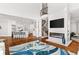 Open concept living space with fireplace, living room and gourmet kitchen featuring modern decor and hardwood floors at 3215 Oxleas Ct, Cumming, GA 30041
