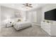 A brightly lit main bedroom with a ceiling fan, white furniture, and plantation shutters at 3215 Oxleas Ct, Cumming, GA 30041