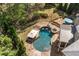 An aerial shot of an in-ground pool with a spa and patio surrounded by mature landscaping at 3215 Oxleas Ct, Cumming, GA 30041