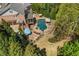 Aerial view of backyard in-ground pool with flagstone patio and professionally landscaped yard at 3215 Oxleas Ct, Cumming, GA 30041
