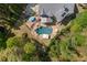 Aerial view of an in-ground pool with flagstone patio, spa, and lush landscaping at 3215 Oxleas Ct, Cumming, GA 30041