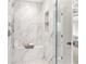 Shower with marble walls, seating and inset shelving at 3215 Oxleas Ct, Cumming, GA 30041