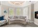 Cozy sitting area with a white curved sofa, shuttered windows, and accent lighting at 3215 Oxleas Ct, Cumming, GA 30041