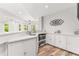 Bright wet bar with white cabinetry, quartz countertop, microwave and wood grain flooring at 3215 Oxleas Ct, Cumming, GA 30041