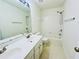 Well-lit bathroom with a double sink vanity, large mirror, and a combination shower and tub at 365 Friars Head Dr, Suwanee, GA 30024