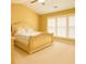 Comfortable bedroom featuring a large window, neutral decor, and a ceiling fan at 365 Friars Head Dr, Suwanee, GA 30024