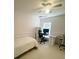 A bright bedroom with a ceiling fan, a bed with white bedding, and a desk with a computer at 365 Friars Head Dr, Suwanee, GA 30024