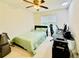 Cozy bedroom featuring neutral walls, a ceiling fan, and a comfortable bed with green bedding at 365 Friars Head Dr, Suwanee, GA 30024