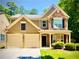 Charming two-story home with a two-car garage and stone facade at 365 Friars Head Dr, Suwanee, GA 30024