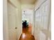Hallway view leading to the dining room with hardwood floors and nearby closet space at 365 Friars Head Dr, Suwanee, GA 30024