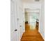 Hallway with hardwood floors leading to a bright living space with natural light and views of the backyard at 365 Friars Head Dr, Suwanee, GA 30024