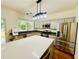 Modern kitchen featuring stainless steel appliances, a large island, and sleek countertops at 365 Friars Head Dr, Suwanee, GA 30024