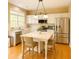 Bright kitchen with stainless steel appliances, a center island, and modern finishes at 365 Friars Head Dr, Suwanee, GA 30024