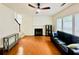 Cozy living room with hardwood floors, a fireplace, and plenty of seating at 365 Friars Head Dr, Suwanee, GA 30024