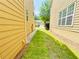 Narrow side yard with newly laid sod between houses, improving drainage with gravel at 365 Friars Head Dr, Suwanee, GA 30024