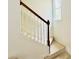 Carpeted staircase with white railings and a wooden handrail leading upstairs at 365 Friars Head Dr, Suwanee, GA 30024