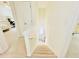 Bright staircase with white carpet, leading to a naturally-lit landing with access to a bedroom and linen closet at 365 Friars Head Dr, Suwanee, GA 30024