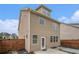 View of the tan siding of the home's exterior with a fenced-in backyard and a small concrete patio at 4044 Elsdon Dr, Austell, GA 30106