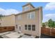 Tan siding on home exterior featuring a fenced-in backyard with a patio area and minimal landscaping at 4044 Elsdon Dr, Austell, GA 30106
