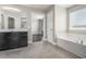 This bathroom features tile floors, a tub, and a dark vanity at 4044 Elsdon Dr, Austell, GA 30106