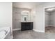 Bathroom featuring a double sink vanity, soaking tub, and walk-in closet at 4044 Elsdon Dr, Austell, GA 30106