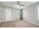 The bedroom features a ceiling fan, carpet, and a window at 4044 Elsdon Dr, Austell, GA 30106