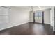 Spacious bedroom with tray ceiling, large windows, and dark hardwood floors at 4044 Elsdon Dr, Austell, GA 30106