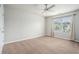 The carpeted bedroom features neutral walls, a window, and a door at 4044 Elsdon Dr, Austell, GA 30106