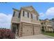 Charming two-story home featuring a two-car garage and stone accents under a bright blue sky at 4044 Elsdon Dr, Austell, GA 30106