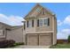 Charming two-story home featuring a two-car garage and neutral siding under a bright blue sky at 4044 Elsdon Dr, Austell, GA 30106