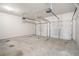 The garage features two garage doors, light-colored walls and a concrete floor at 4044 Elsdon Dr, Austell, GA 30106