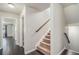Hallway with carpeted staircase and hardwood floors leading to various rooms at 4044 Elsdon Dr, Austell, GA 30106