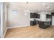 Bright eat-in kitchen features stainless appliances, granite countertops, an island, and stylish light fixtures at 4044 Elsdon Dr, Austell, GA 30106