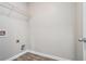 This is a simple laundry room with wood floors and a wire shelf at 4044 Elsdon Dr, Austell, GA 30106