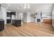 Open-concept kitchen and living room with hardwood floors and views to back yard at 4044 Elsdon Dr, Austell, GA 30106