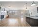 Open-concept living room and kitchen with hardwood floors and views to back yard at 4044 Elsdon Dr, Austell, GA 30106