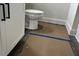 Bathroom includes a white toilet next to the vanity, and flooring covered with brown protective paper at 3536 Dogwood Pass, Stonecrest, GA 30038