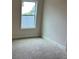 Bright bedroom featuring a large window and neutral carpeting at 3536 Dogwood Pass, Stonecrest, GA 30038
