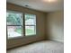 Bedroom with two large windows offering views of the home's exterior and neighborhood at 3536 Dogwood Pass, Stonecrest, GA 30038