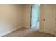 Bedroom featuring neutral carpeting with convenient access to doors at 3536 Dogwood Pass, Stonecrest, GA 30038