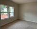 Bright bedroom with neutral carpet and walls, illuminated by natural light streaming through the windows at 3536 Dogwood Pass, Stonecrest, GA 30038