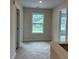 Open bedroom area featuring neutral carpeting and natural lighting with two doors at 3536 Dogwood Pass, Stonecrest, GA 30038