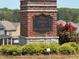 Stonecrest neighborhood entrance sign amid beautiful green shrubs and plants at 3536 Dogwood Pass, Stonecrest, GA 30038