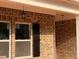 Attractive brick home showcasing lantern-style porch lighting and dark window shutters at 3536 Dogwood Pass, Stonecrest, GA 30038