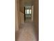 Long hallway leading to a bright room with windows, offering natural light at 3536 Dogwood Pass, Stonecrest, GA 30038