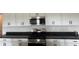 Well-equipped kitchen showcasing white cabinets, a gas stove, and dark countertops for a modern look at 3536 Dogwood Pass, Stonecrest, GA 30038