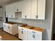 New kitchen featuring modern white cabinets and drawers, waiting for finishing touches at 3536 Dogwood Pass, Stonecrest, GA 30038