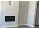 Cozy living room with a modern electric fireplace and neutral paint at 3536 Dogwood Pass, Stonecrest, GA 30038