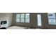 Bright living room with large windows and modern fireplace, creating an inviting space at 3536 Dogwood Pass, Stonecrest, GA 30038