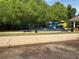 A colorful playground surrounded by lush greenery provides a fun and safe space for children to play at 3536 Dogwood Pass, Stonecrest, GA 30038